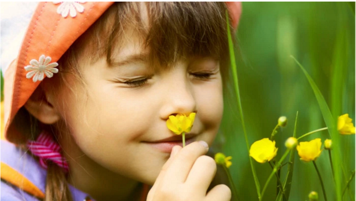 Girl Smelling Flowers